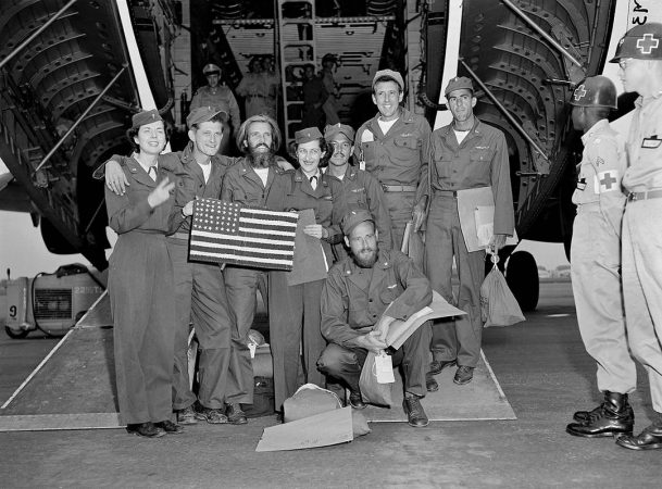 Repatriated Air Force pilots display a home made American flag made in captivity during the Korean War